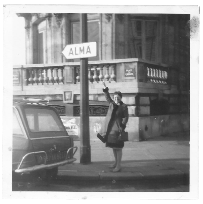 Florence Gottlieb pointing at a sign that says "ALMA"