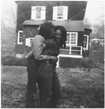 A black and white photo of two people embracing