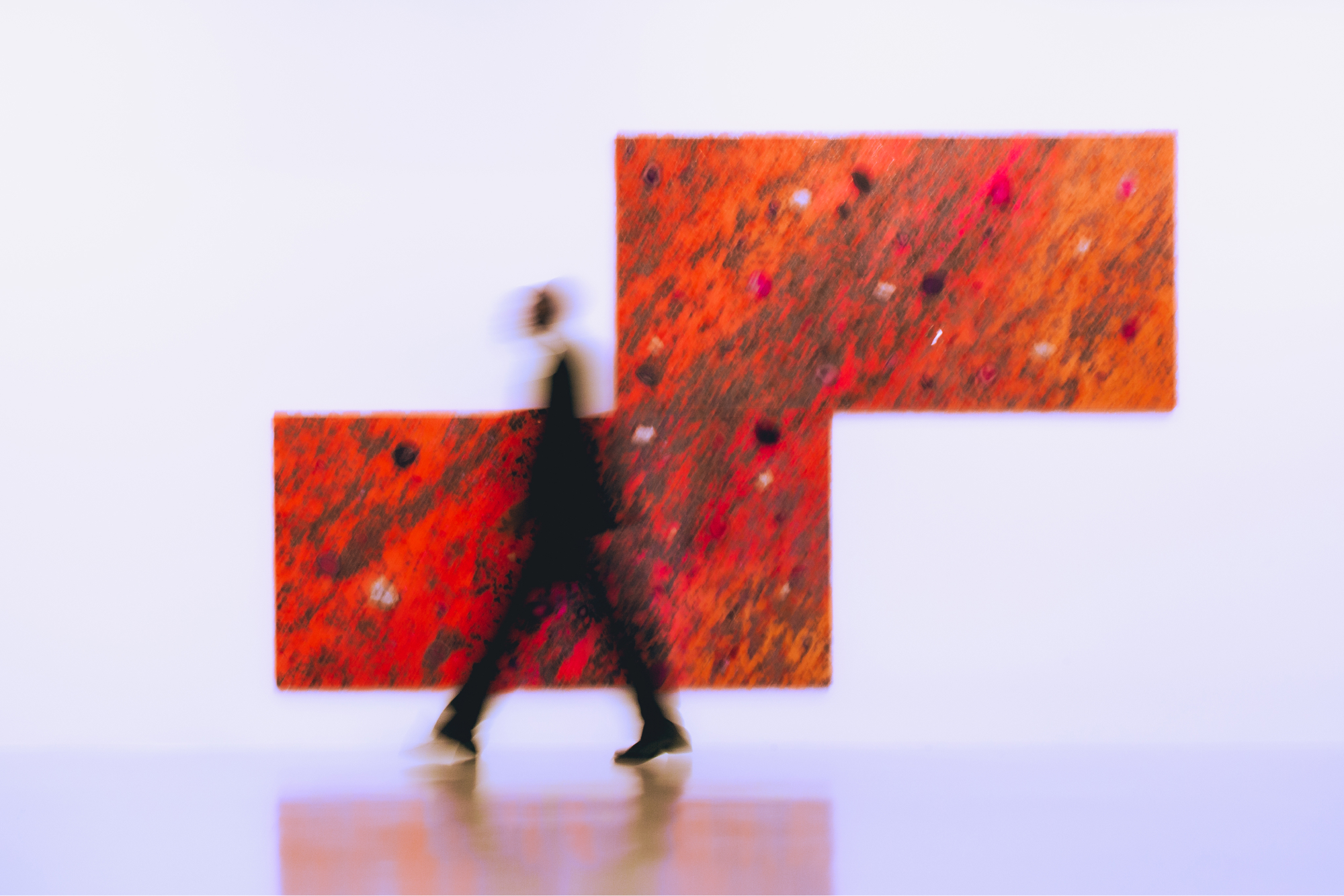 In-situ photograph of person walking past artworks by Alteronce Gumby in Nicola Vassel Gallery.